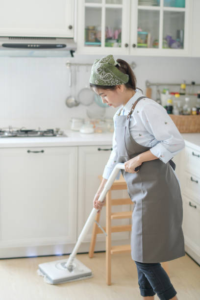 istock A young maid cleaning the house with a mop 1266894643
