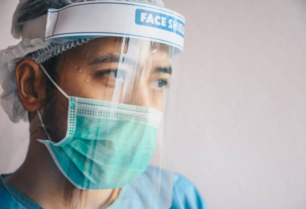 istock Male Doctor having tired from work while wearing PPE suit for protect coronavirus disease. 1266895693