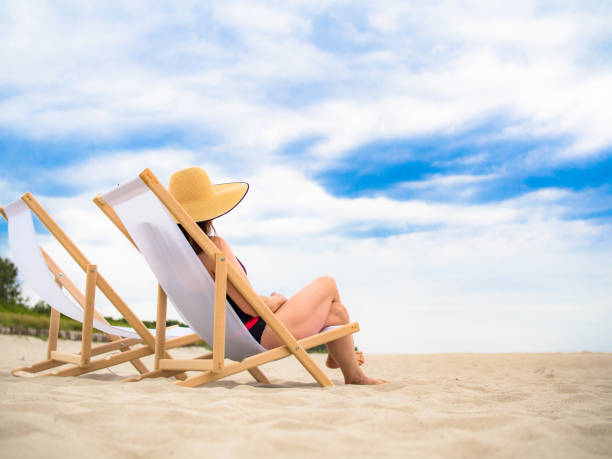 istock Woman relaxing on beach 1266895774