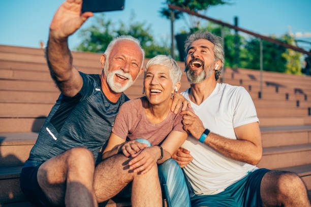 istock Cheerful mature friends taking selfie after working out 1266896778