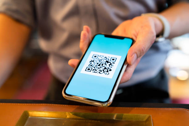 istock Men who use QR codes to make contactless payments using their smartphones 1266900503
