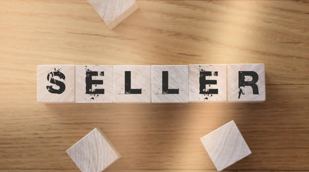 istock Seller, word cube with background. Business concept 1266908508