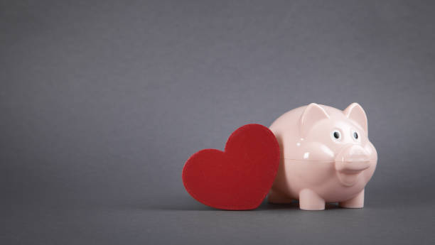istock Piggy bank with red heart. 1266908847