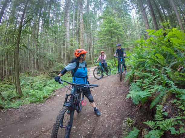 istock Multi-Ethnic, Multi-Generation Family and Friends Mountain Biking on Forest Trail 1266909425