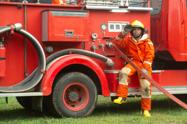 istock The fireman is preparing to put out the fire at the fire engine. Because the fire was burning in the building. 1266909448