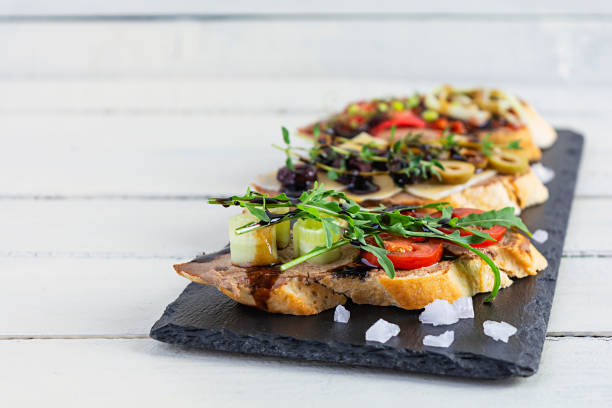 istock Bruschetta with chicken liver paste. Delicious bruschettas with various fillings. Different bruschetta ob wooden background 1266913013