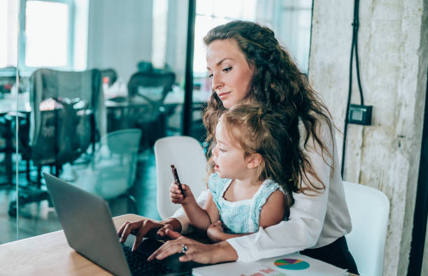 istock Single mother with her child working in office. 1266919008