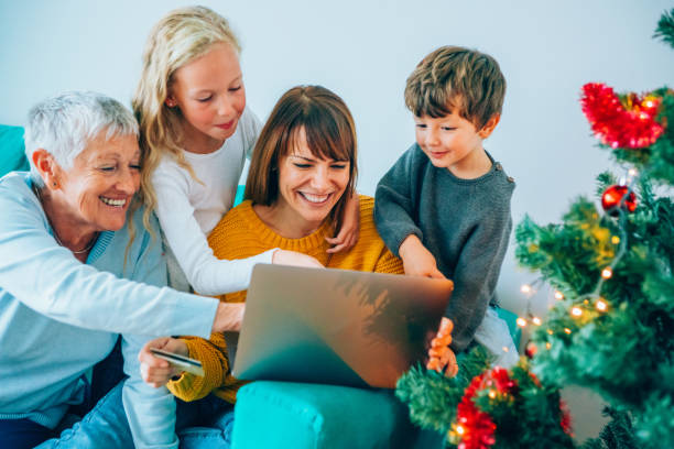 shopping di famiglia multi-generazione online a natale - christmas shopping internet family foto e immagini stock