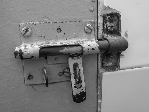 Old rusty lock closing a door