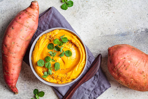 Sweet potato hummus gray bowl, top view. Sweet potato hummus in a gray bowl. sweet potato photos stock pictures, royalty-free photos & images