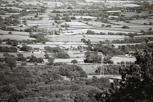 White powerlines running through patchwork fields in Dorset/Devon borders. 35mm black and white film