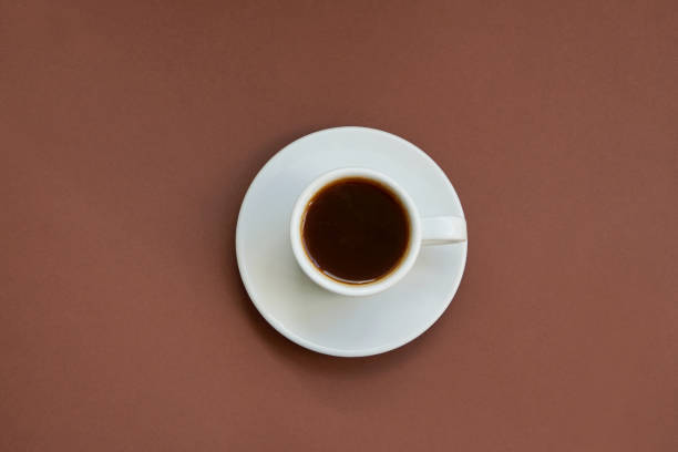 istock White cup of strong coffee on brown background Copy space 1266923108