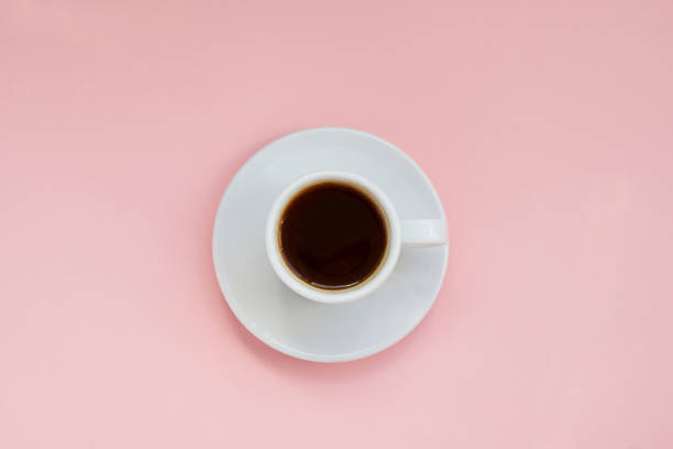 istock White cup of strong coffee on pink background Copy space 1266923112