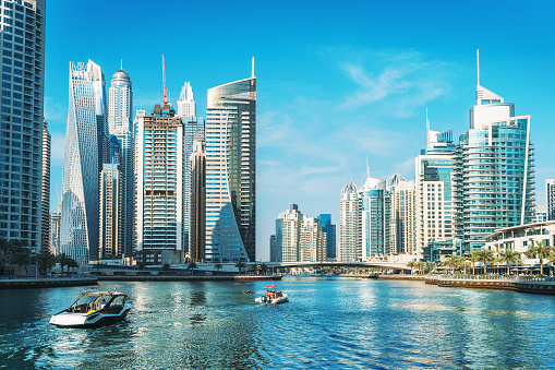Panorama of Dubai Marina in UAE, modern skyscrapers and port with luxury yachts.
