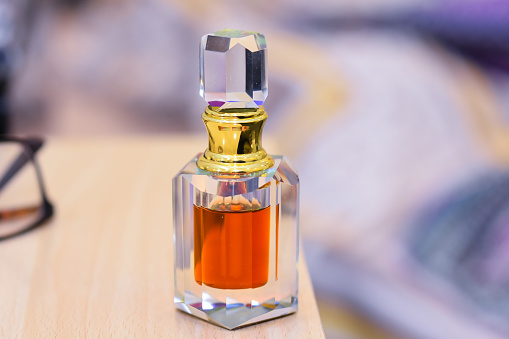 arabic perfume called oud in a crystal bottle and blurry background