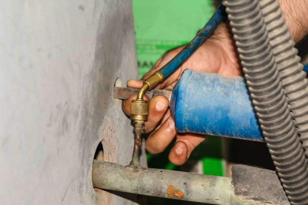 istock gas is being refiling into the heavy  ac compressor of central air conditioning system 1266929737