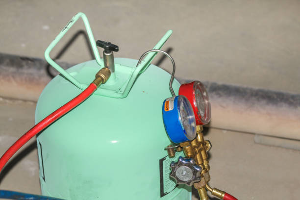 istock gas is being refiling into the heavy  ac compressor of central air conditioning system 1266929738