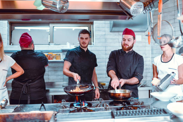 istock Busy Kitchen Team Trying To Maintain Busy Schedule 1266929907