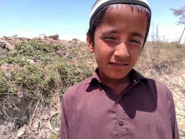 smiling child standing outside in sunny day