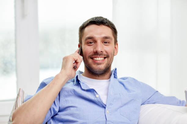 istock happy man calling on smartphone at home 1266931123