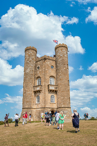 Tourist queuing up to visit the famous Broadway Tower on a lovely Summers day, sitting high in the Cotswold landscape. Broadway Tower is a folly on Broadway Hill, near the large village of Broadway and is the second-highest point of the Cotswolds (312m) after Cleeve Hill  (330m)