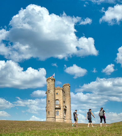Tourist visiting the famous Broadway Tower on a lovely Summers day, sitting high in the Cotswold landsacpe. Broadway Tower is a folly on Broadway Hill, near the large village of Broadway and is the second-highest point of the Cotswolds (312m) after Cleeve Hill  (330m)
