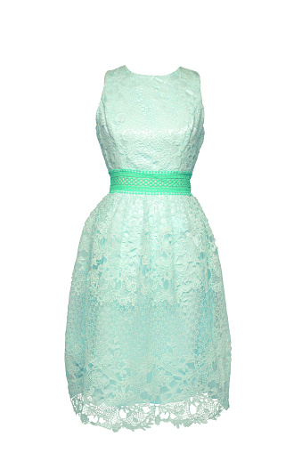 Lacy dress isolated. Closeup of a turquoise green stylish sleeveless evening dress with lace on mannequin isolated on a white background. Summer fashion.