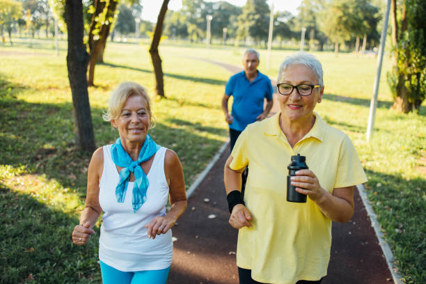 istock Seniors jogging in park 1266937803