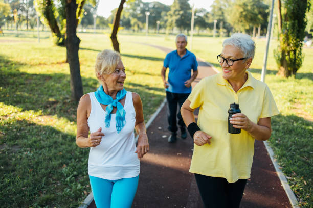 istock Seniors jogging in park 1266937824