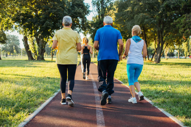 istock Seniors jogging in park 1266937850
