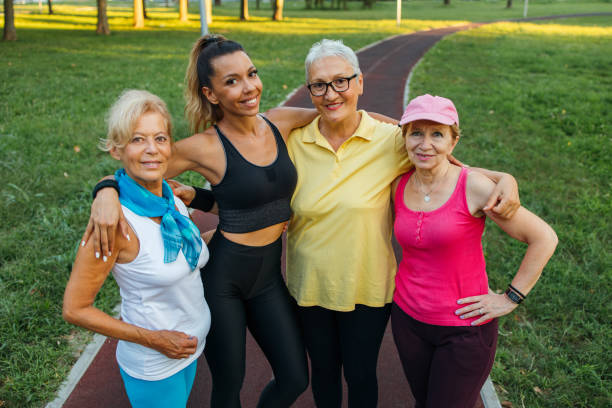 istock Active senior women with fitness instructor in park 1266938113