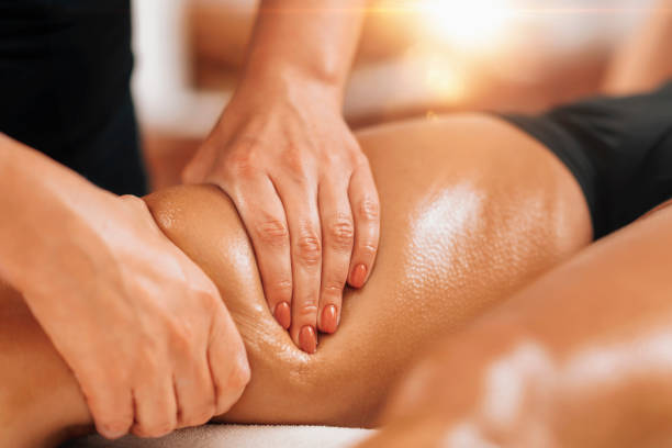 Anti Cellulite Thigh Massage in a Beauty Spa Salon. Anti cellulite female thigh massage at a beauty spa salon. Body care concept. drainage photos stock pictures, royalty-free photos & images