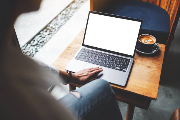 istock a businesswoman using and touching on laptop touchpad with blank white desktop screen in cafe 1266939216