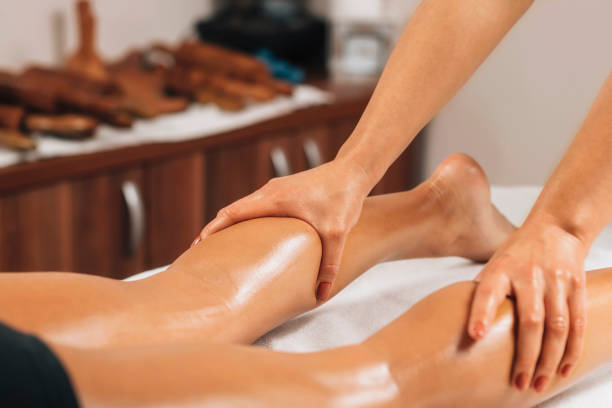 istock Anti Cellulite Massage. Masseuse Massaging a Female Calf 1266939448