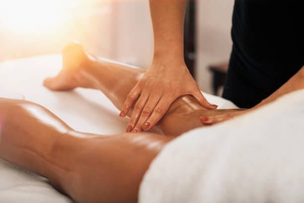 Anti Cellulite Massage. Masseuse Massaging a Female Calf Anti cellulite massage. Masseuse massaging a calf area of a female leg to reduce cellulite drainage photos stock pictures, royalty-free photos & images