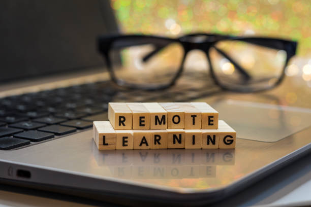 istock REMOTE LEARNING virtual learning concept with wood block letters on laptop 1266942853