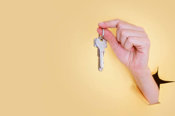 istock A female hand holding a house key 1266944441