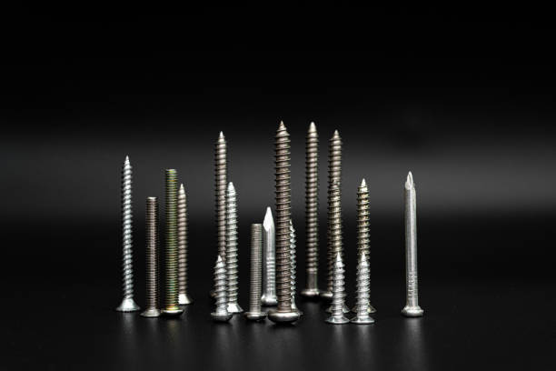 istock Screws and nails on a black background 1266946727