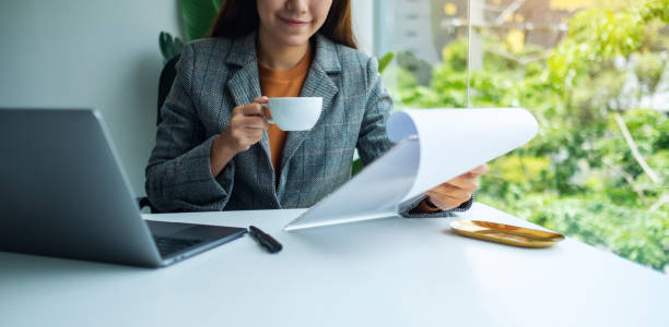 istock Businesswoman working on financial paperwork and laptop computer 1266946955