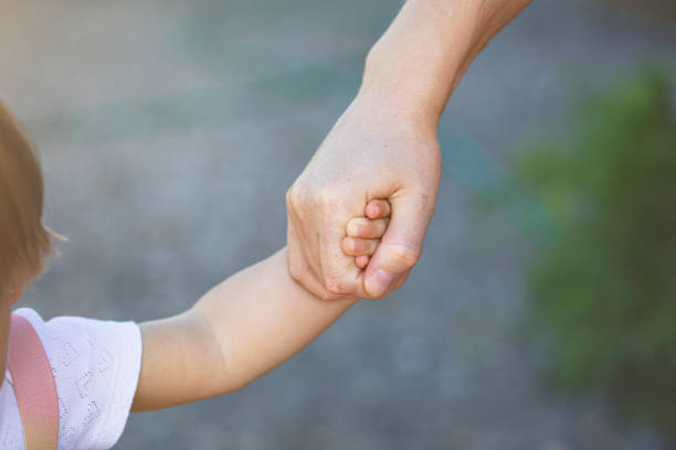 istock Mother's and a child hands 1266947816