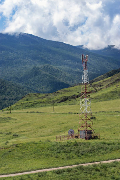 istock Red and white cell tower in a wild mountainous area. 1266947968