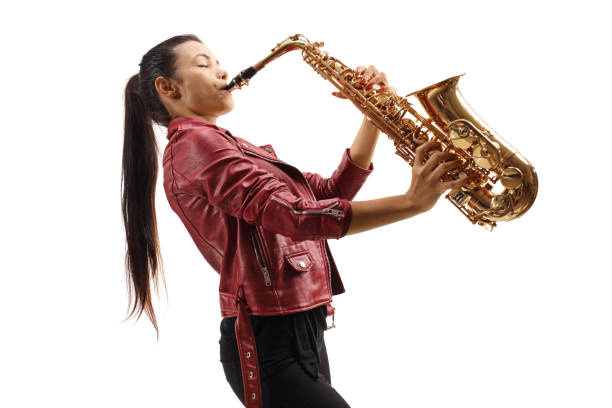 istock Female saxophonist in a red leather jacket playing a sax 1266951177