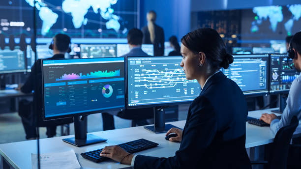 istock Team of Professional Computer Data Science Engineers Work on Desktops with Screens Showing Charts, Graphs, Infographics, Technical Business Data and Statistics. Dark Control and Monitoring Room. 1266953128