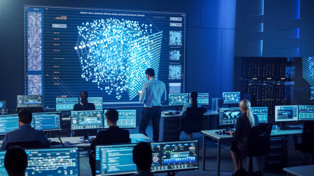 istock Team of Professional Computer Data Science Engineers Work on Desktops with Screens Showing Charts, Graphs, Infographics, Technical Neural Network Data and Statistics. Dark Control and Monitoring Room. 1266953202