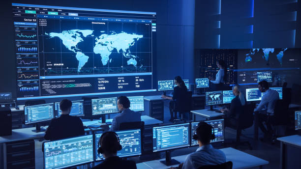 istock Team of Professional Computer Data Science Engineers Work on Desktops with Screens Showing Charts, Graphs, Infographics, Technical Neural Data and Statistics. Dark Control and Monitoring Room. 1266953279