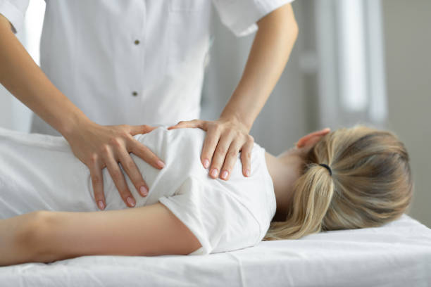Woman having chiropractic back adjustment Woman having chiropractic back adjustment chiropractor photos stock pictures, royalty-free photos & images