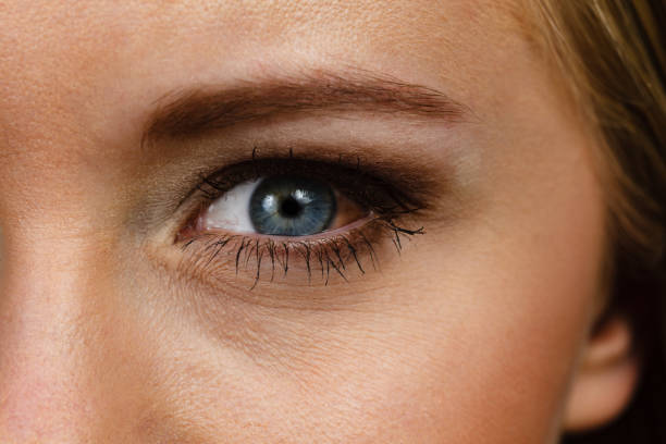 istock Close up female eye with red spot 1266955989