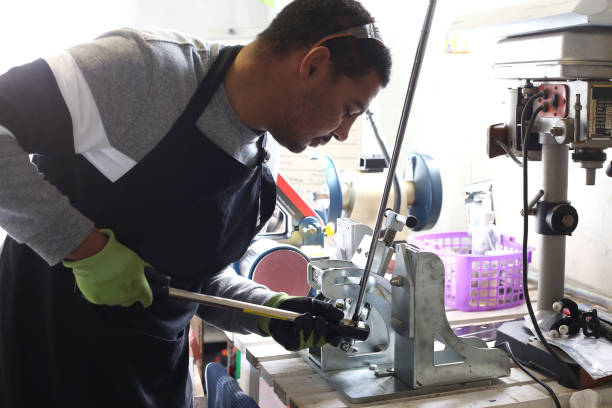 istock Golf Club Builder repairs a golf club 1266957148