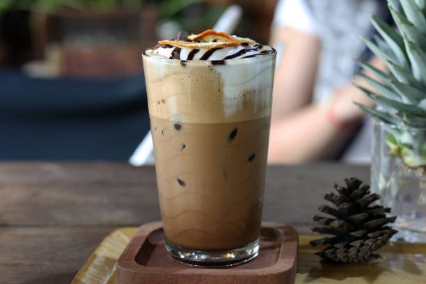 istock Mocha coffee with layer in crystal glass on wooden table background 1266957661