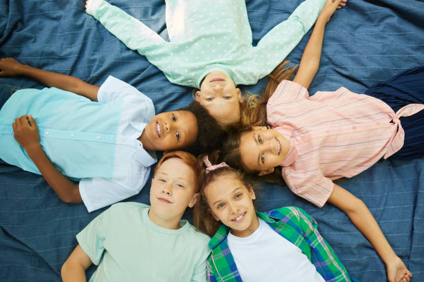 istock Children Lying in Circle Outdoors 1266959793